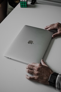 a person's hands on a laptop