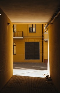 a yellow building with a black door