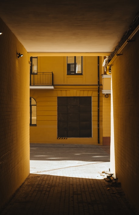 a yellow building with a black door