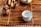 A small ceramic cup sits on a bamboo mat alongside a ceramic figurine resembling an animal. The arrangement includes tea utensils and a teapot, creating a serene and traditional tea setting.