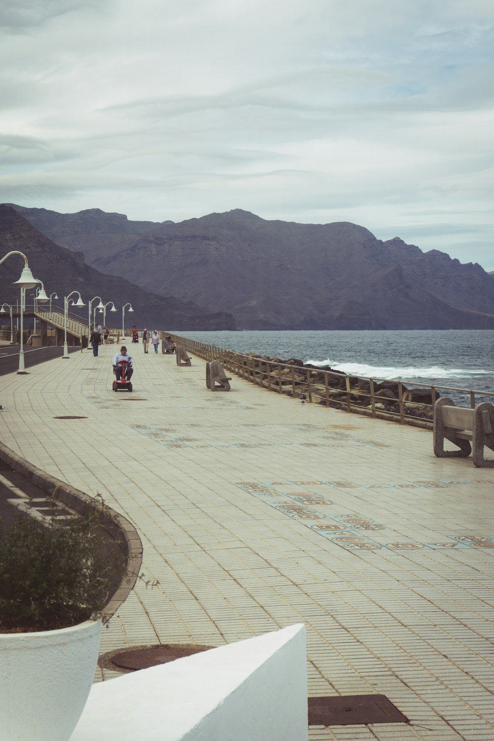 a stone walkway next to a body of water