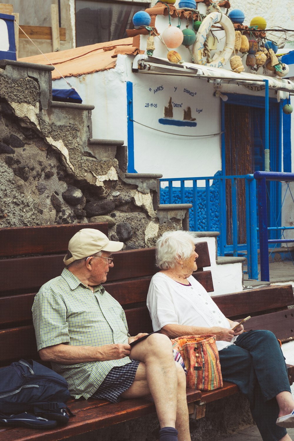 an old couple sitting on a bench