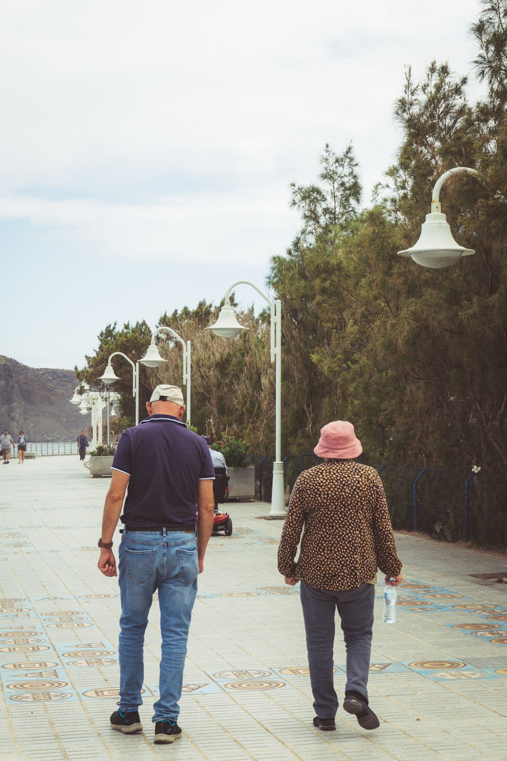 a man and woman walking on a sidewalk