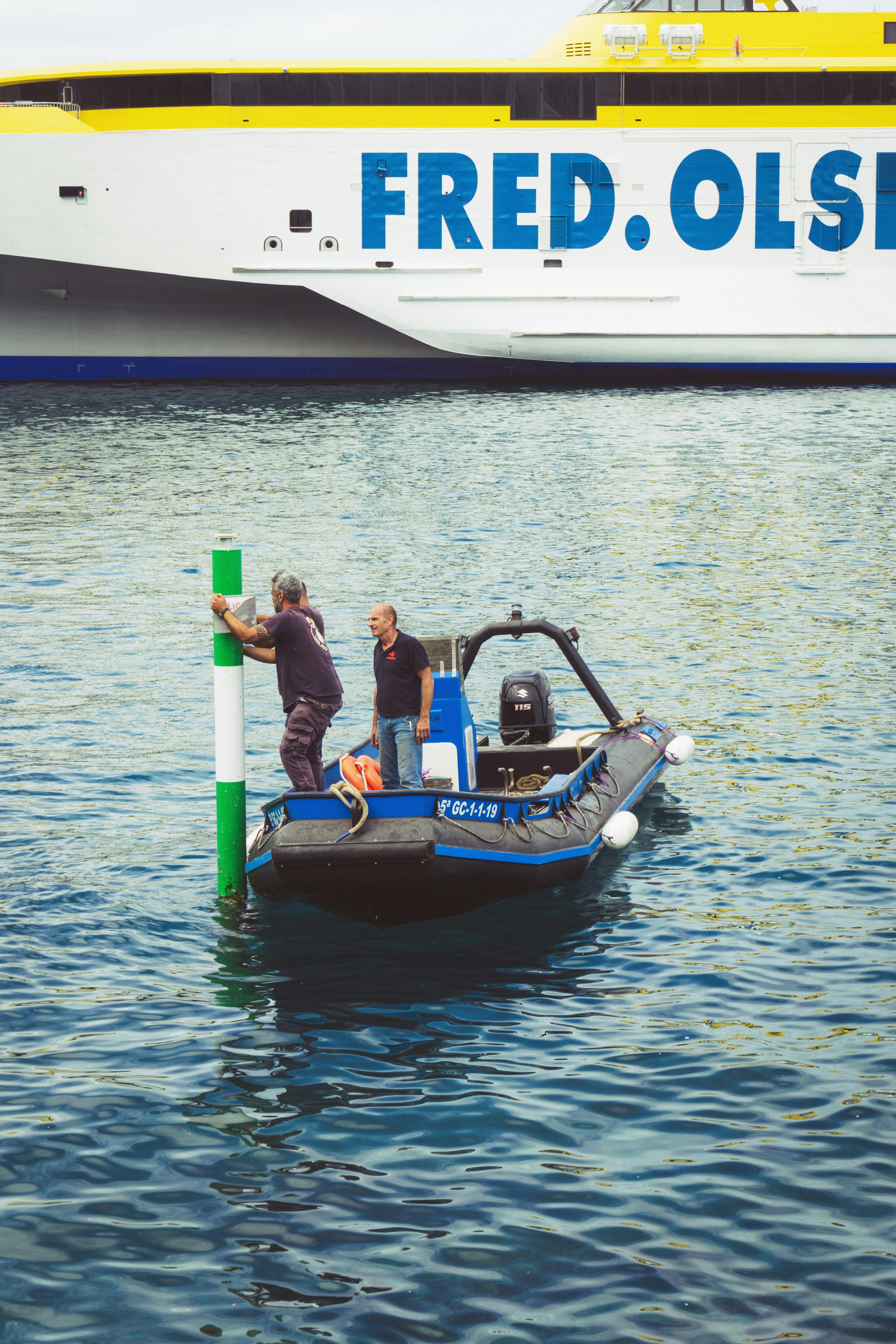 a couple of people stand on a boat