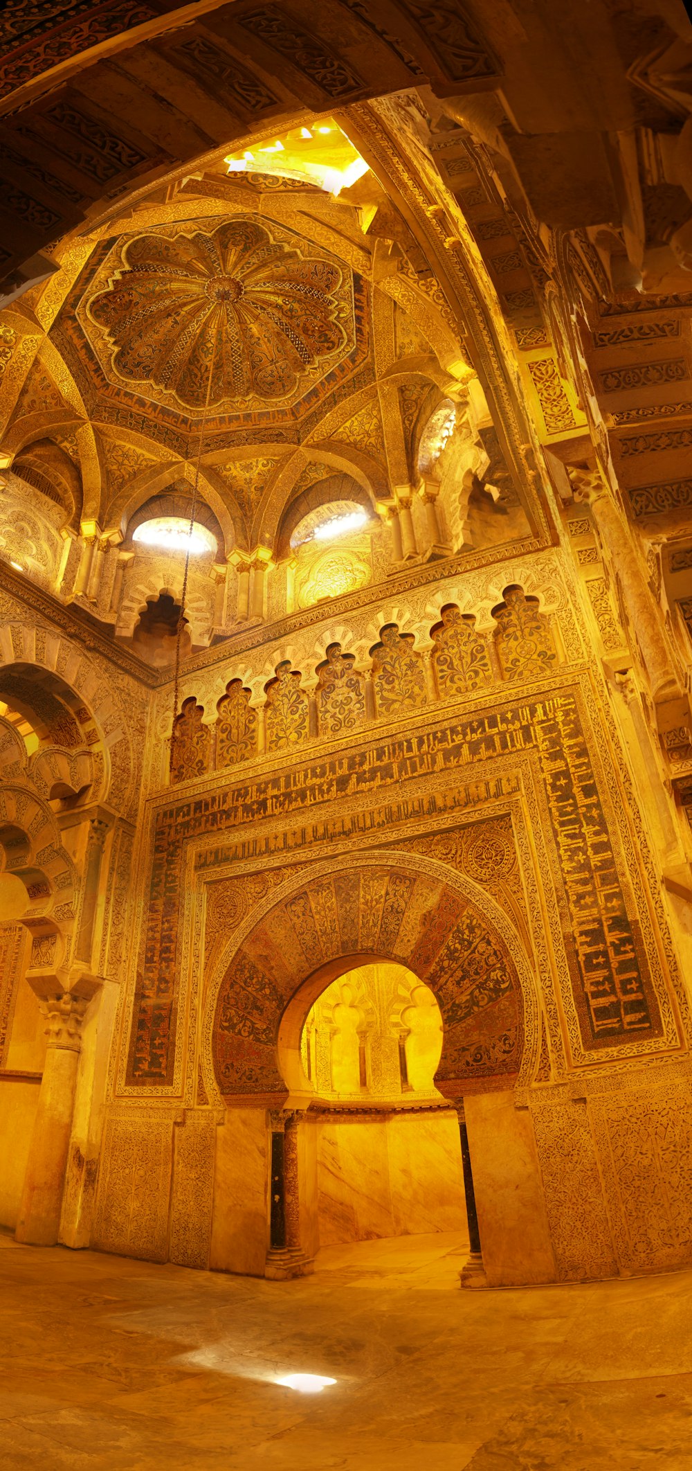 a large ornate room with a large ceiling and statues