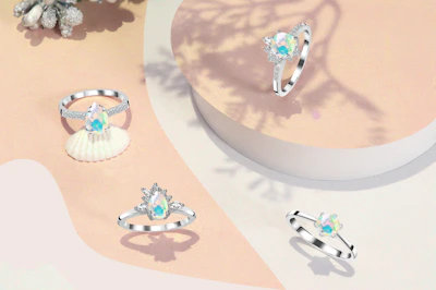 Shimmering silver rings arranged artistically on a wooden table