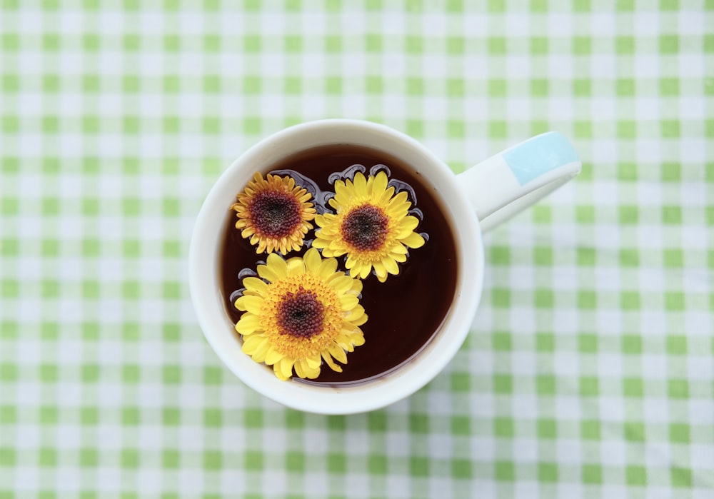 a cup of coffee with a flower design on the side