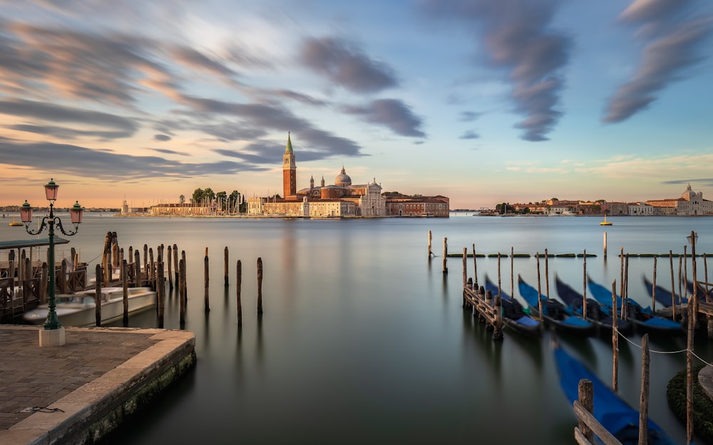 a body of water with boats and buildings in the background