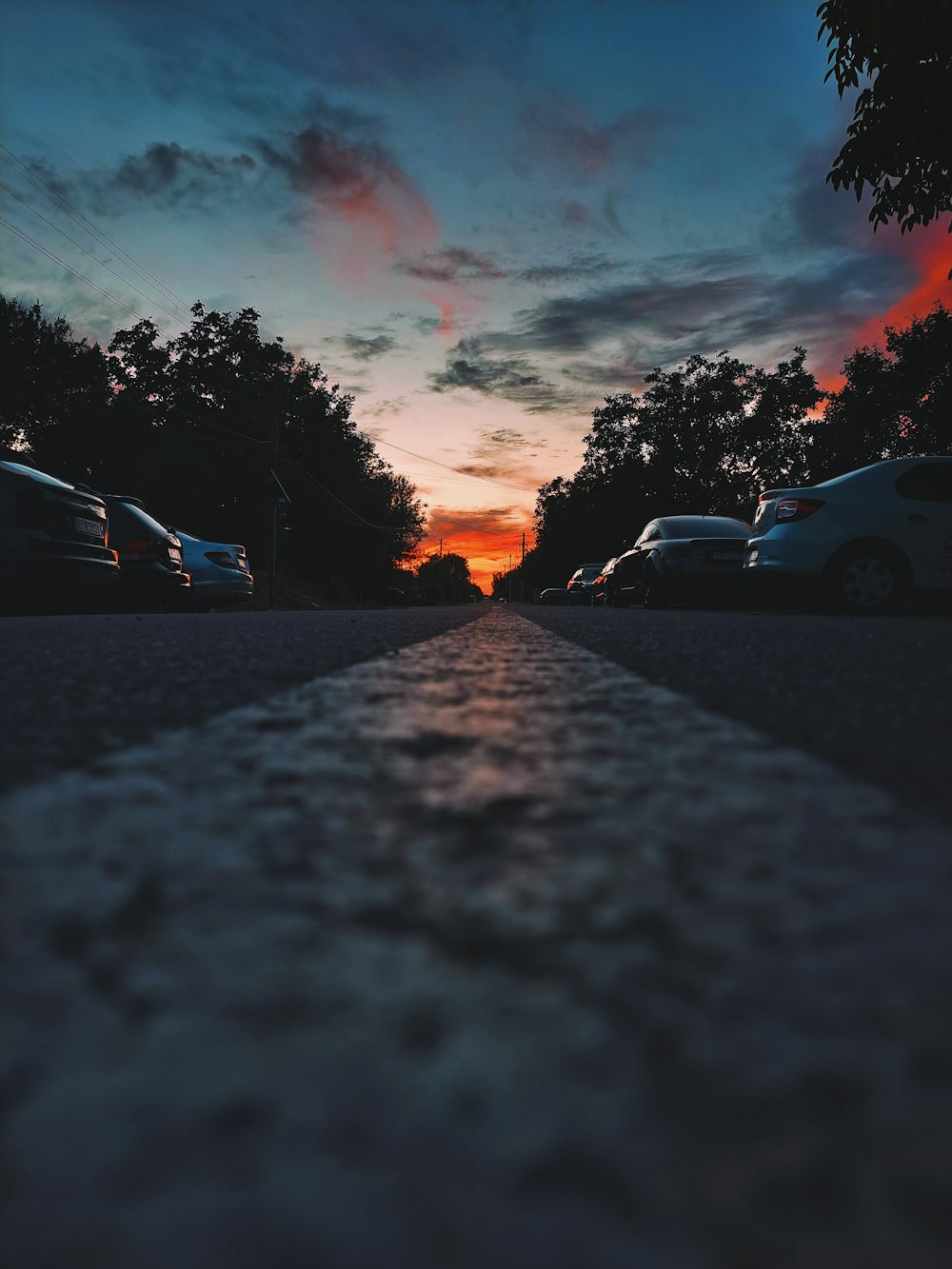 a sunset over a parking lot