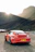 Toyota Supra parked on a mountain road during sunset, showcasing its sleek lines.