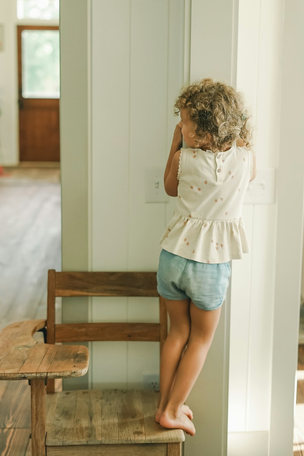 a child standing on a chair