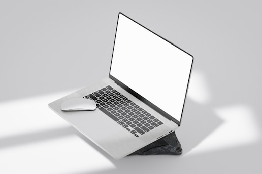 A minimalist black and white laptop screen showing a clean, modern website layout.