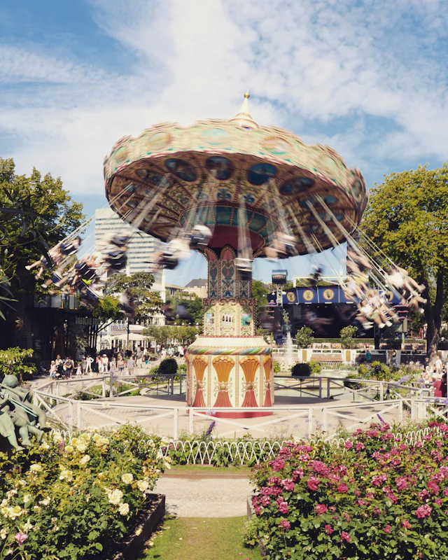 Tivoli Gardens' spinning chair carousel ride framed by flowerbeds
