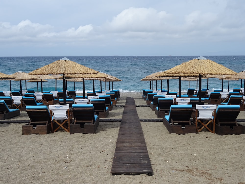 a beach with umbrellas and chairs