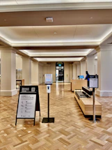 A welcoming receptionist at a congress information desk ready to assist attendees.