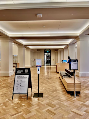 A welcoming receptionist at a congress information desk ready to assist attendees.