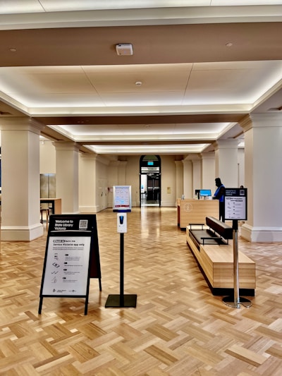 Professional cleaning team sanitizing a public building lobby with eco-friendly supplies.