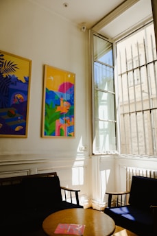 A vibrant metal print hanging perfectly on a living room wall, framed by natural light.