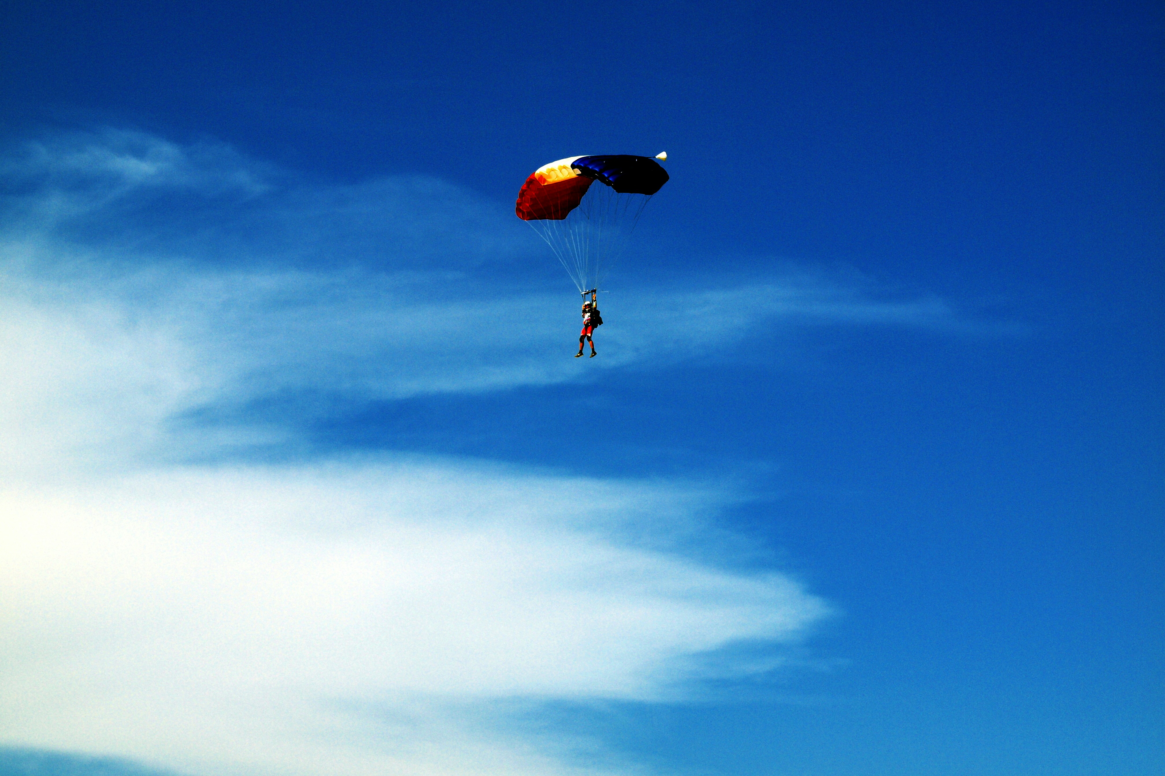 a person in the air with a parachute