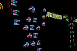 A surreal, fog-filled room illuminated by static from a broken screen, with stripes of deep red light.