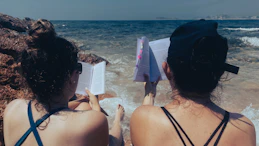 a woman standing next to a body of water