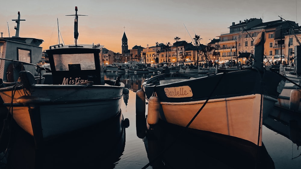 a small boat in a body of water with a city in the background