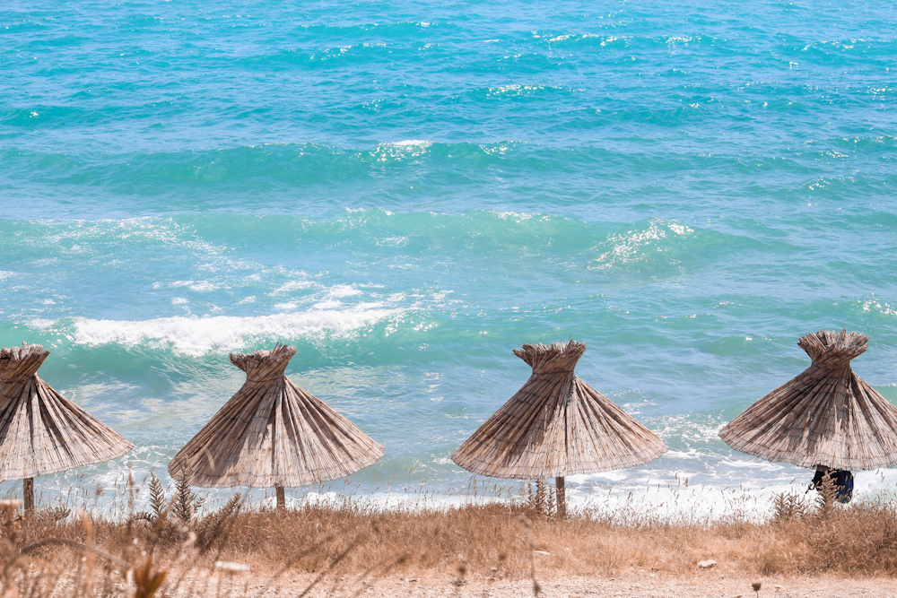 straw umbrellas on a beach