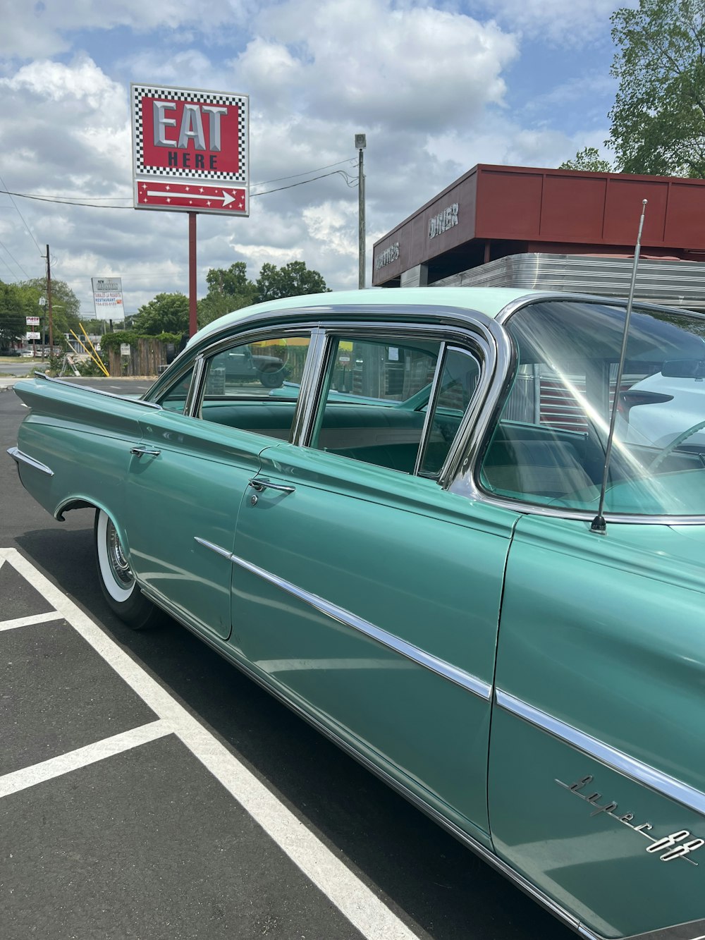 a green car parked in a parking lot