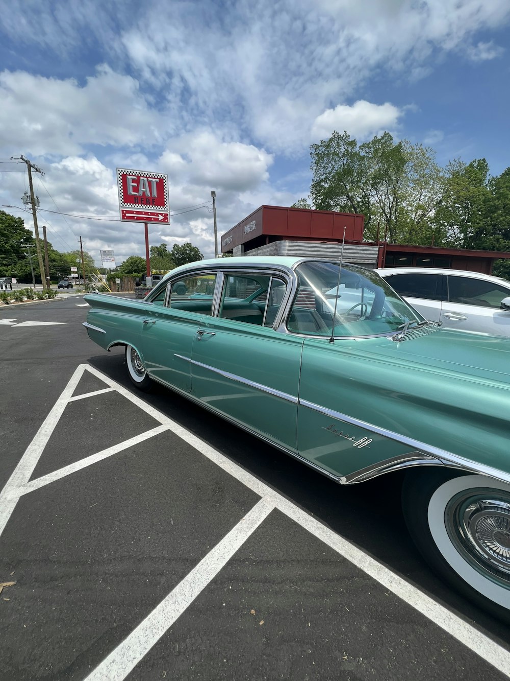 a green car parked in a parking lot