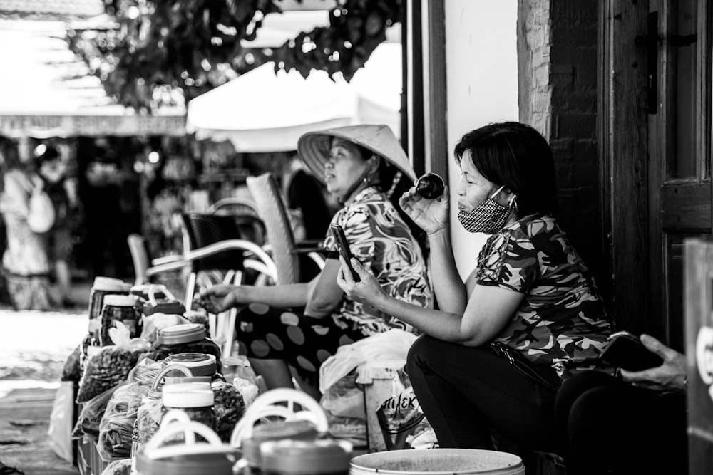 a woman and a man sitting outside