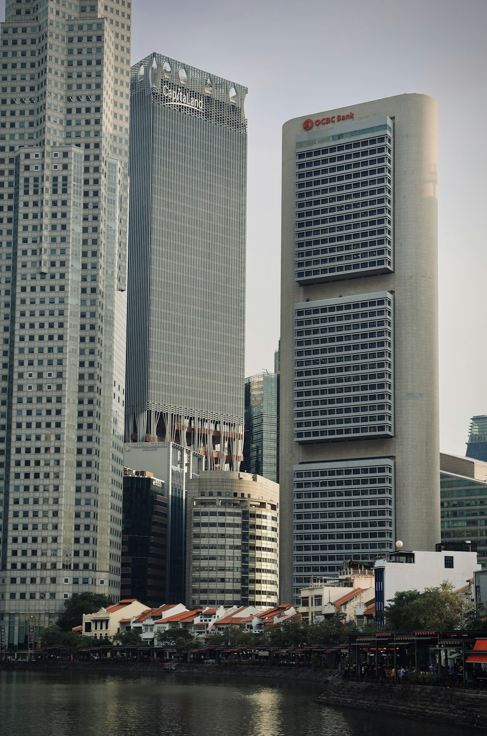 a group of tall buildings next to a body of water