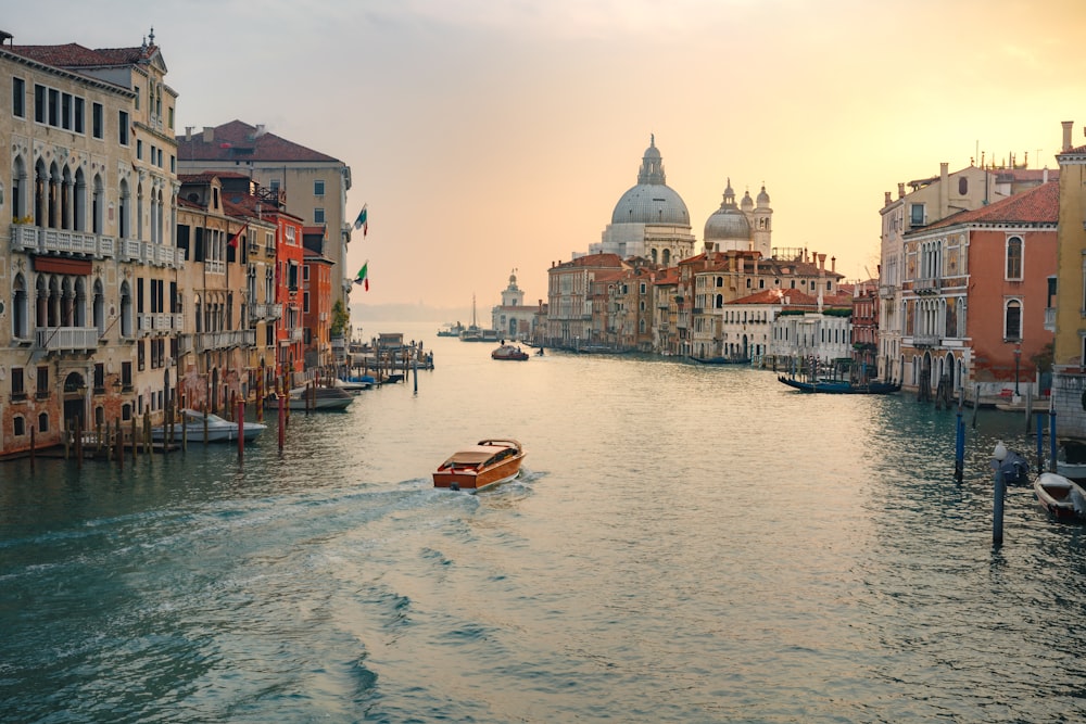 a river with boats in it and buildings around it with Grand Canal in the background