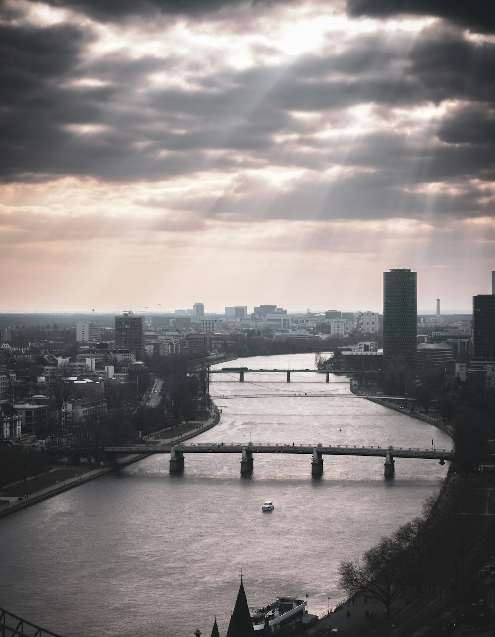 a bridge over a river with a city in the background