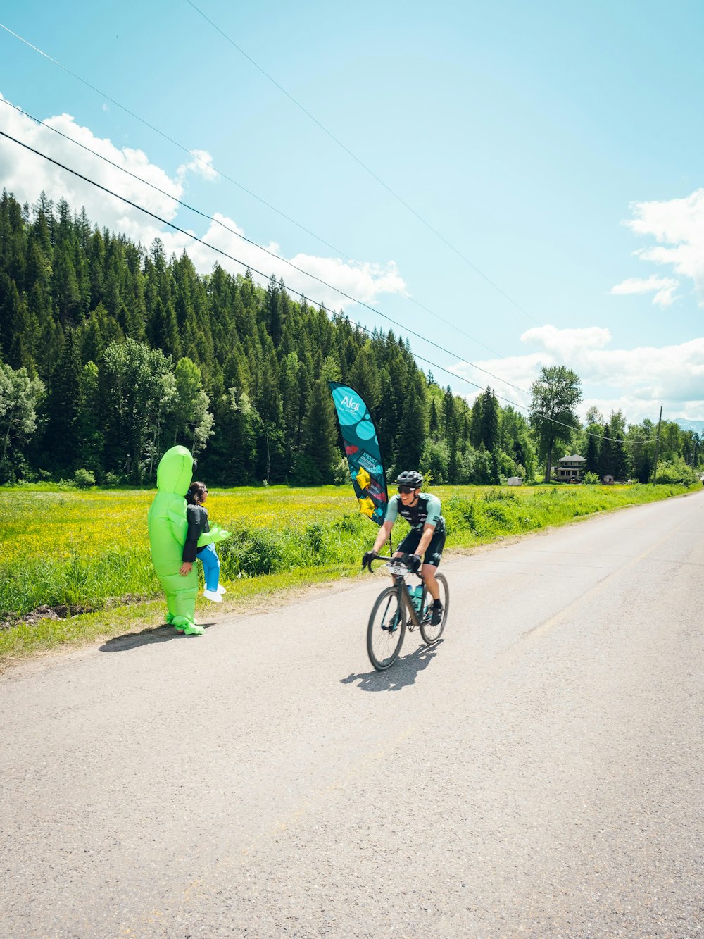 a person on a bicycle with a person in a garment on the side