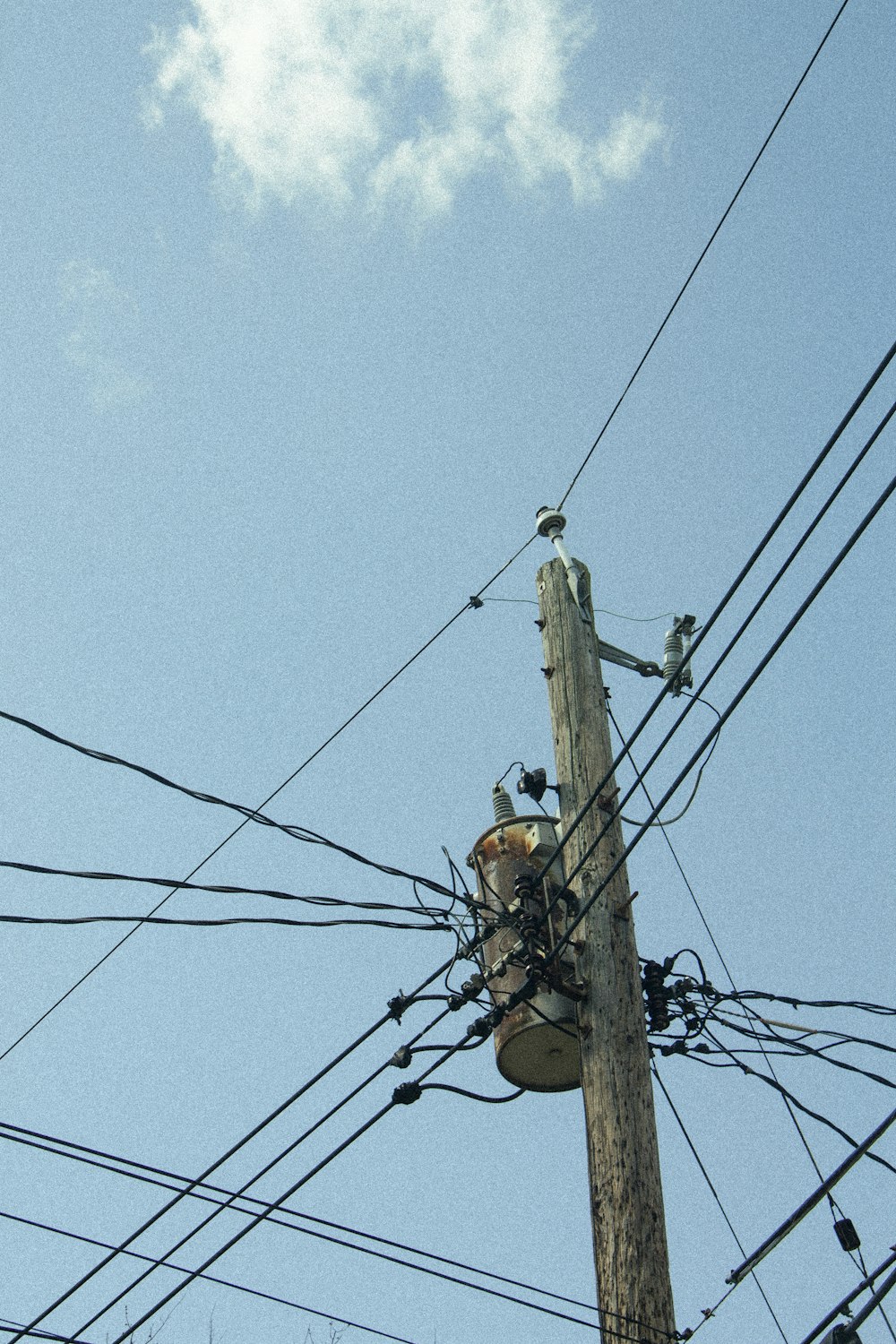 a telephone pole with many wires