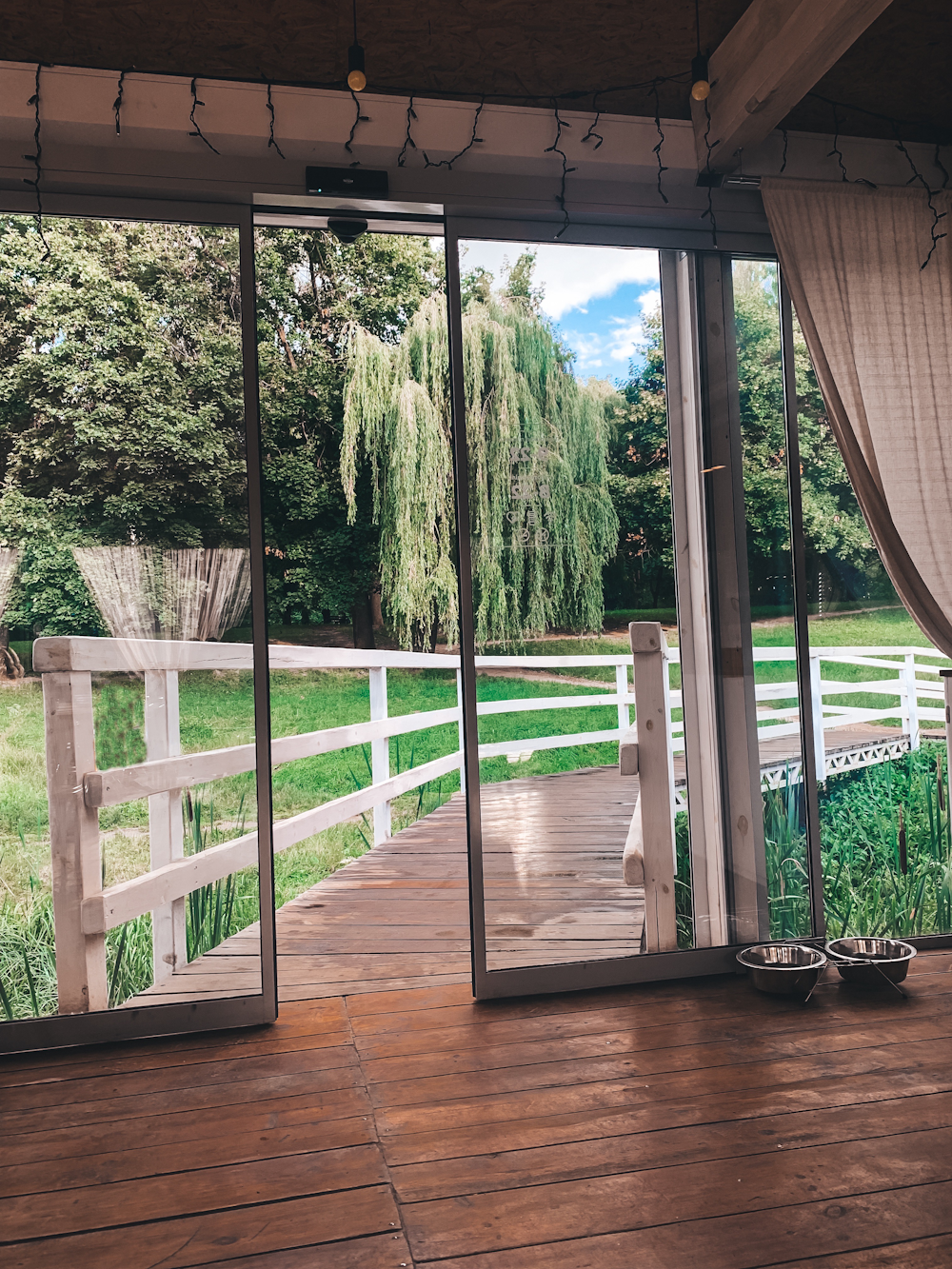 a porch with a railing and trees