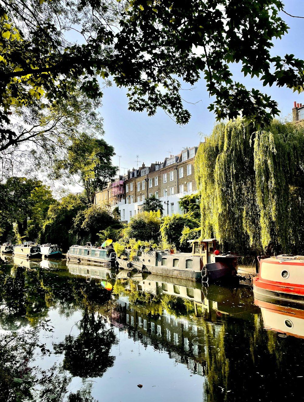 a body of water with boats and buildings along it