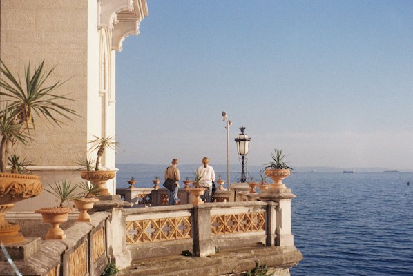 A group of people standing on a balcony overlooking the ocean — Trieste, Italy