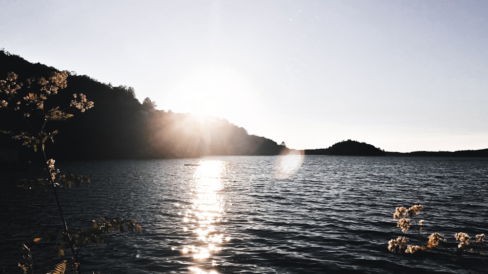 a body of water with a rainbow