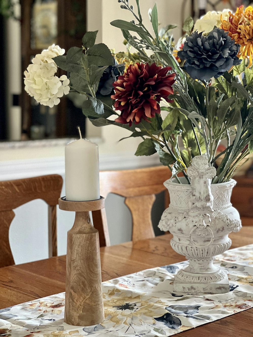 a candle in a vase with flowers