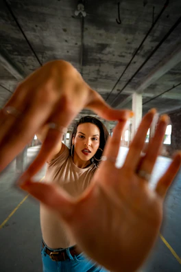 Focused young model practicing expressions in front of a mirror during training.