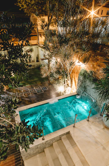 a pool with trees around it