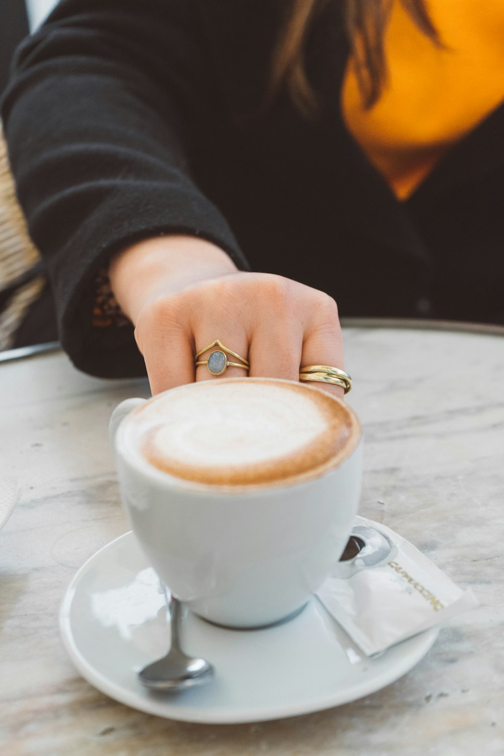 a person holding a cup of coffee