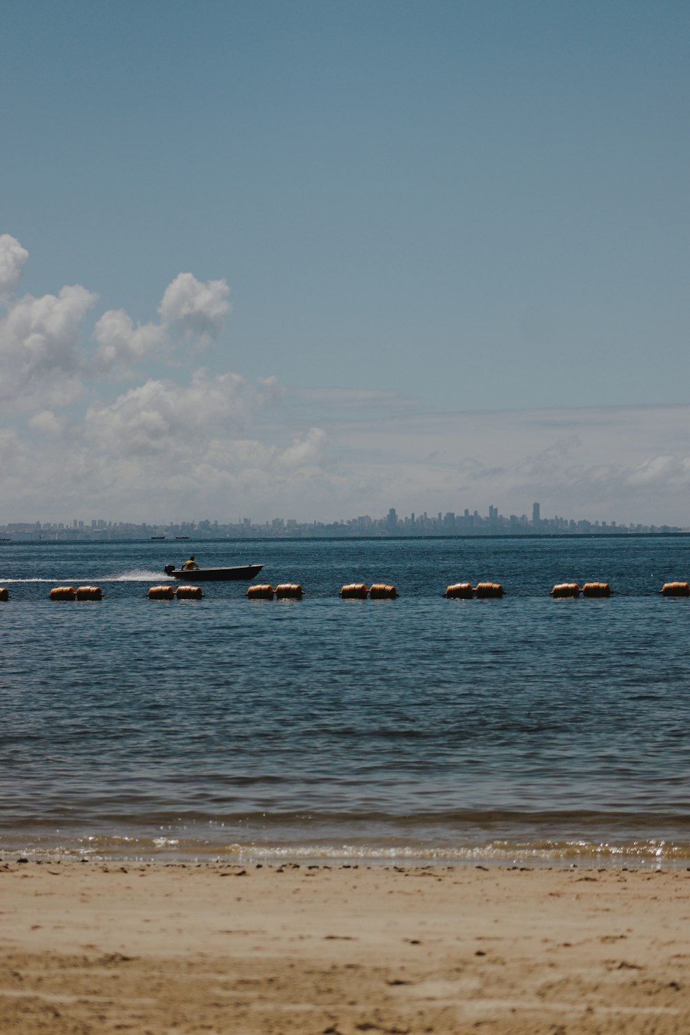 a beach with boats in the water
