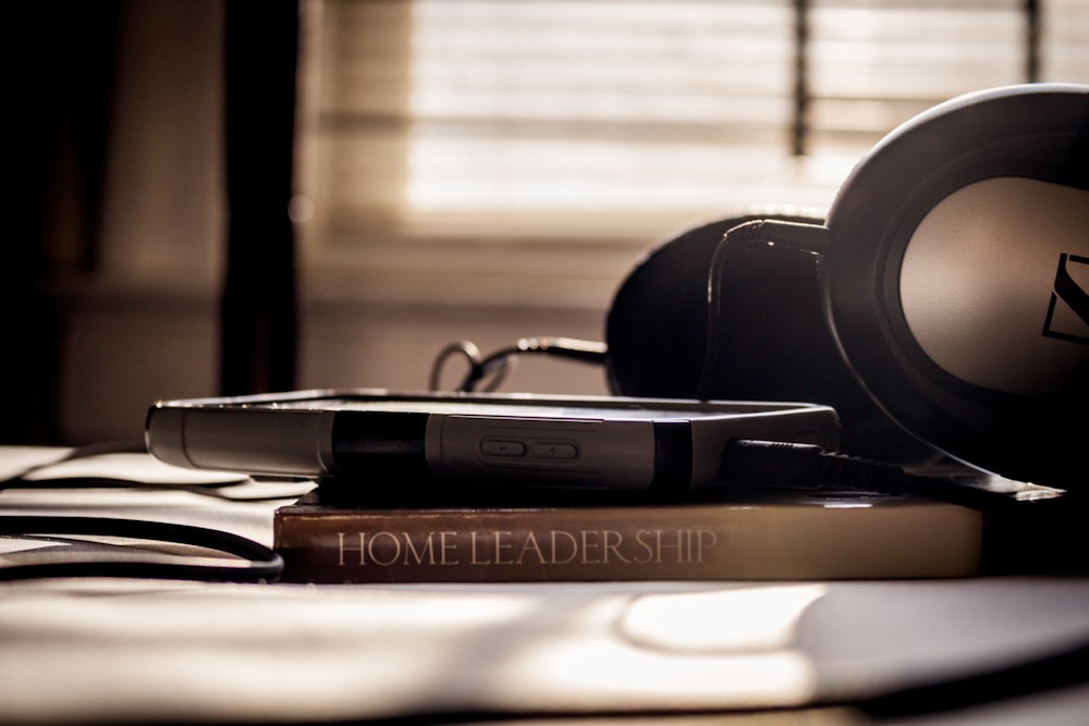 a pair of headphones on top of a stack of books