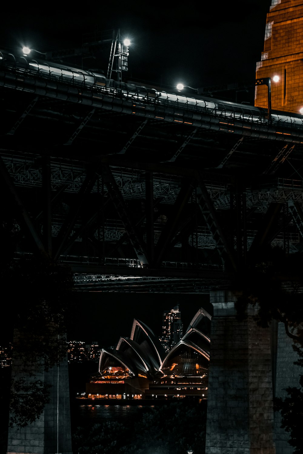 a large metal bridge at night