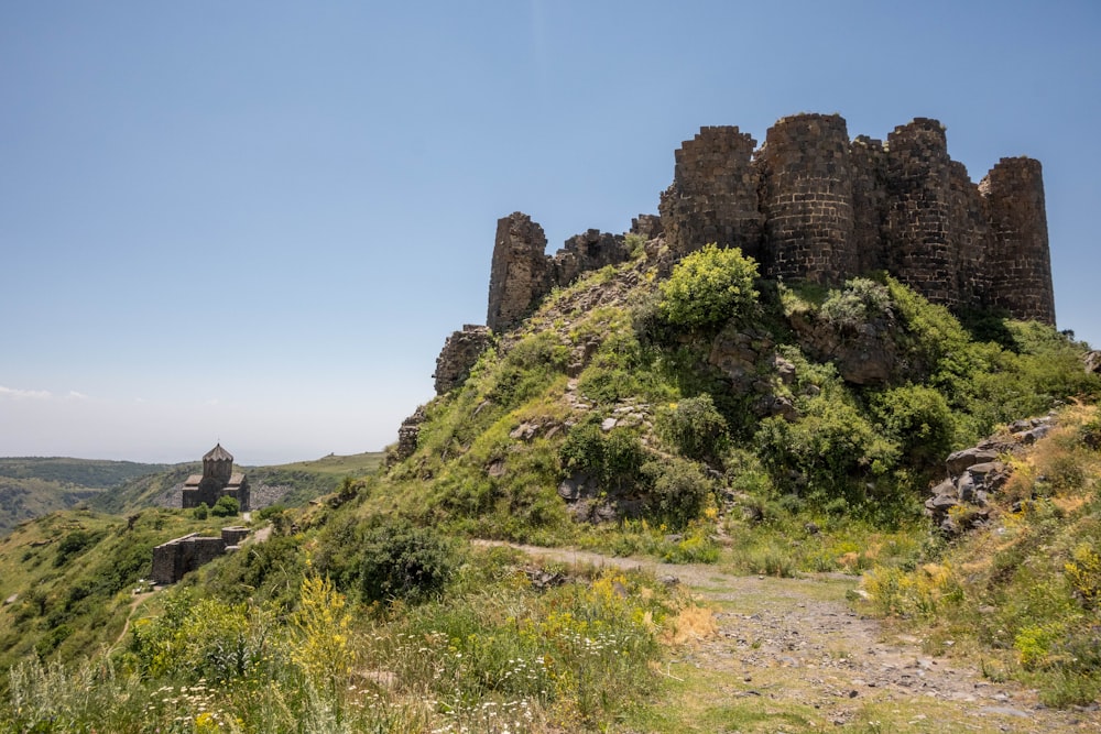 a rocky cliff with trees and bushes