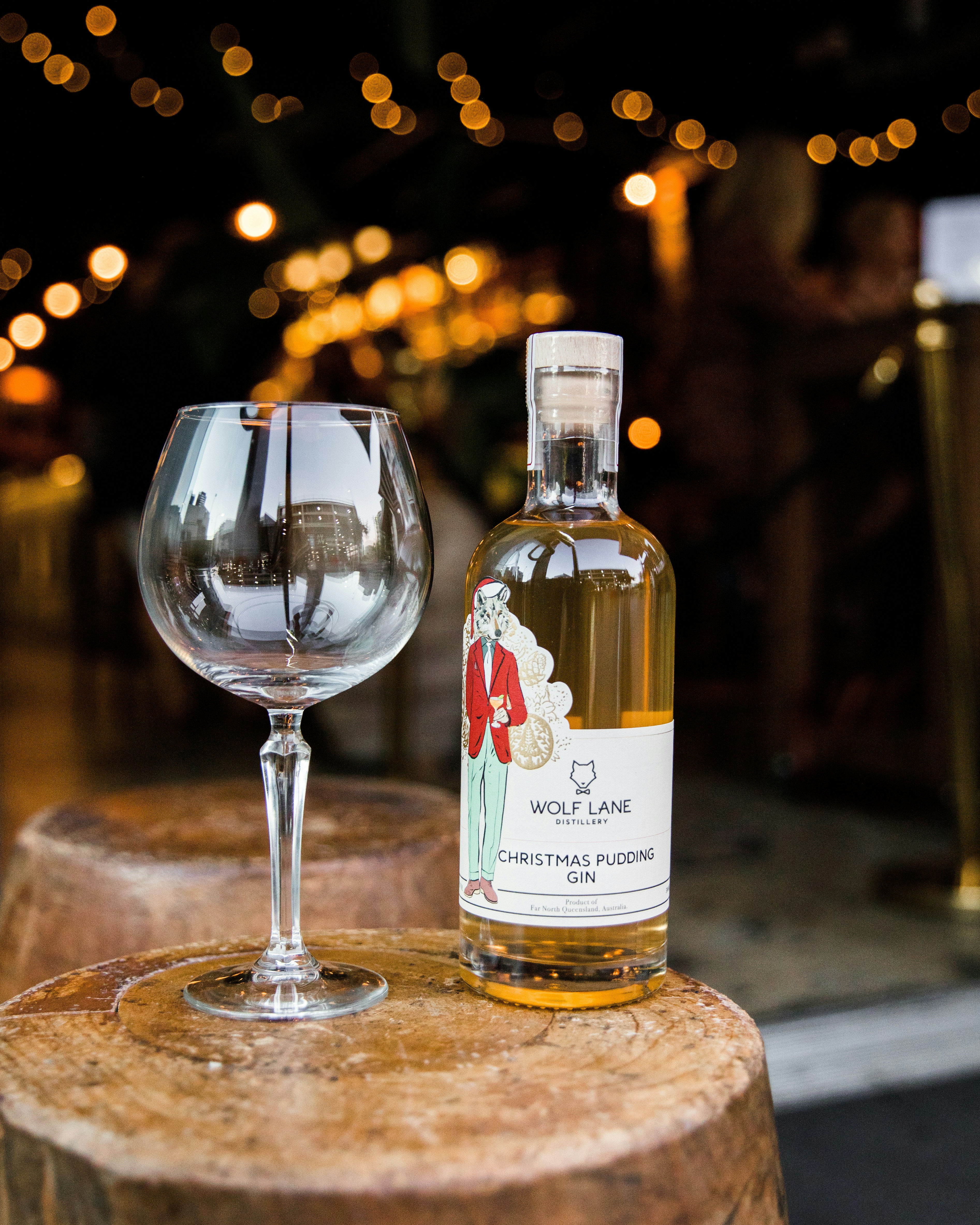 a bottle of alcohol next to a glass of wine