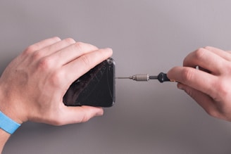 a person holding a black object