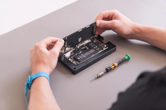 hands holding a black device
